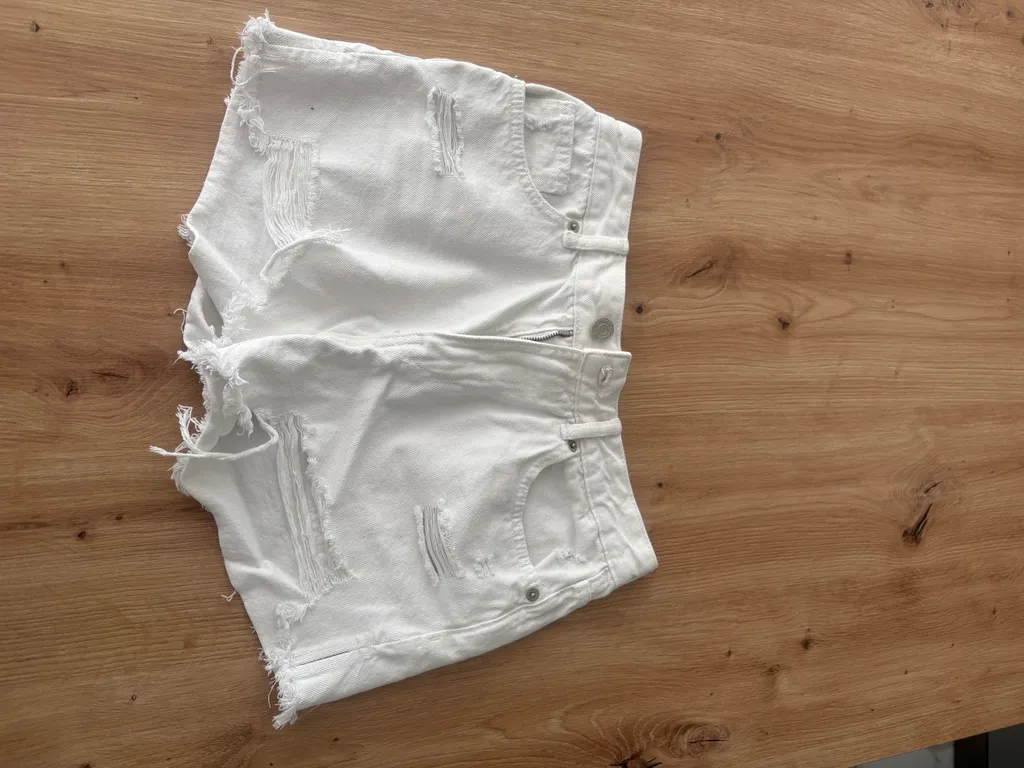 Phone photo of a white denim shorts